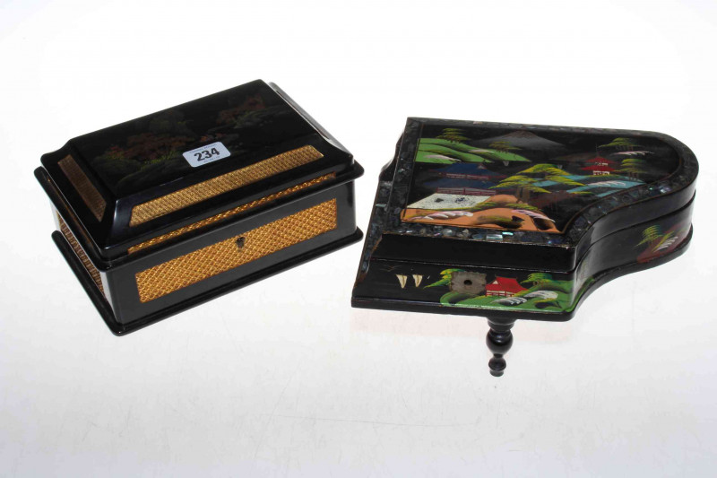 Two vintage black lacquer jewellery boxes depicting Oriental scenes, the piano shaped one is a musical box also, both 22cm (2).