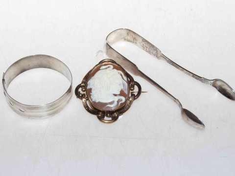 Silver bangle, tongs and cameo brooch.
