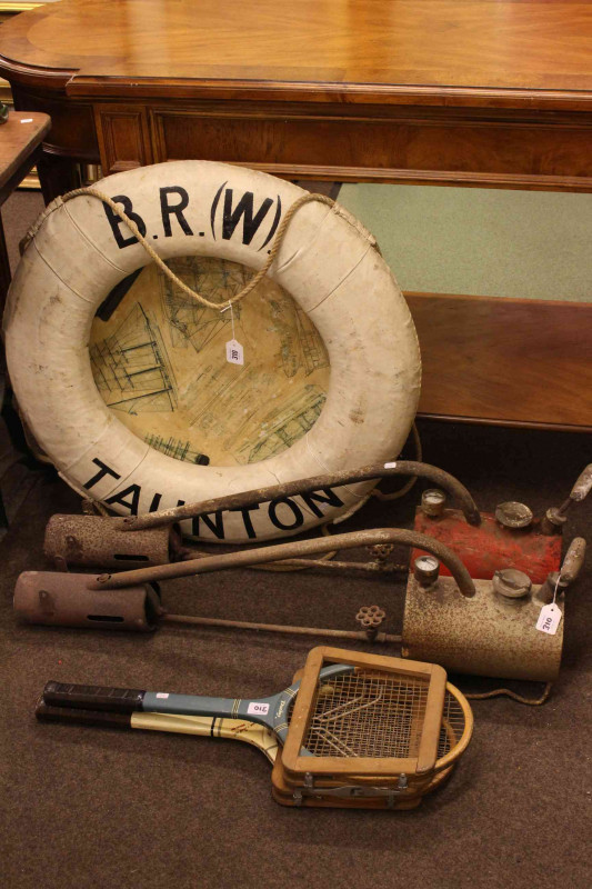 Two flame throwers, novelty life buoy, pair iron candle stands and two tennis racquets (7).