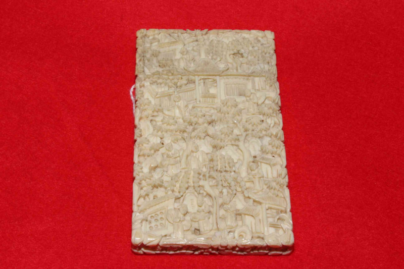 Chinese ivory card case profusely carved with figures in exterior scenes, circa 1900, 10cm x 5.5cm