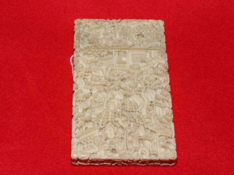 Chinese ivory card case profusely carved with figures in exterior scenes,...