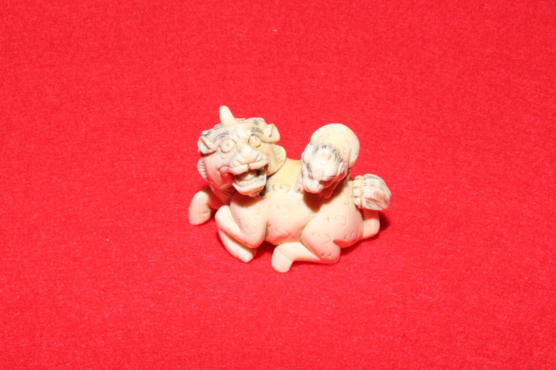 Antique ivory netsuke of beast with cub