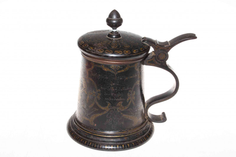 German lidded iron tankard with gilt decoration on black, scroll handle, with inscription and dated 1878, 21cm