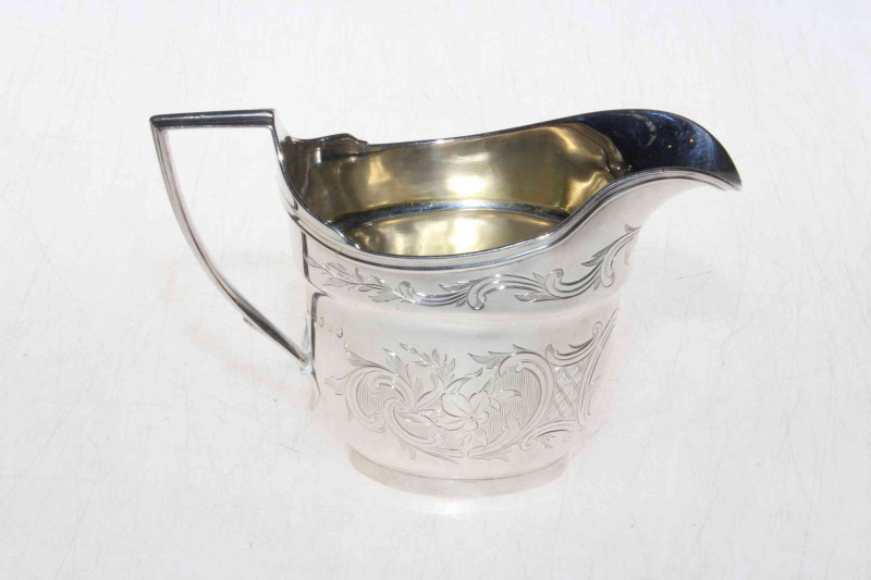 George III silver cream jug by John Emmes, London 1803, having engraved scrolling foliate decoration, 4.5oz