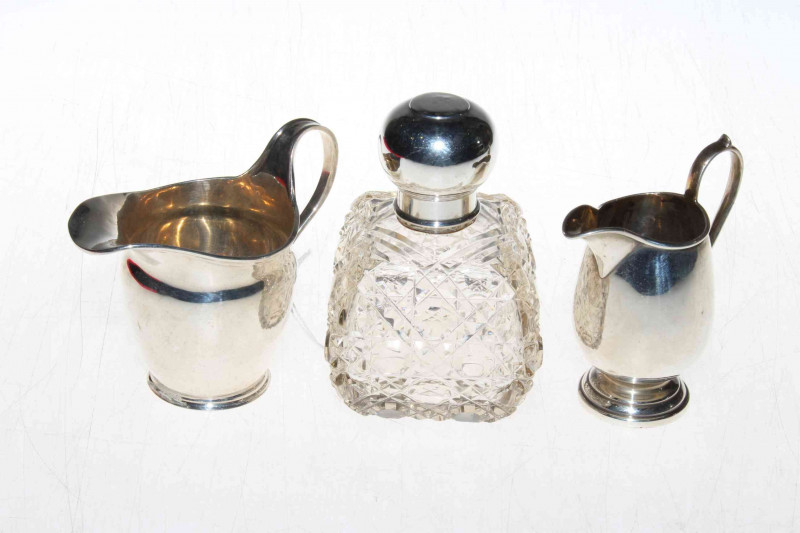 Two silver cream jugs and silver topped crystal scent bottle (3)